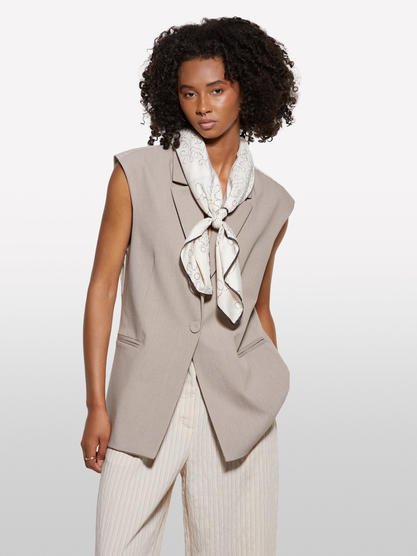 Beige vest with clashing stripe